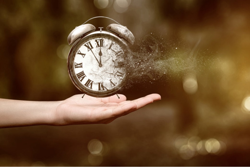 Palm of hand holding an alarm clock.