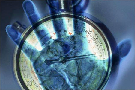 Image of hand holding clock